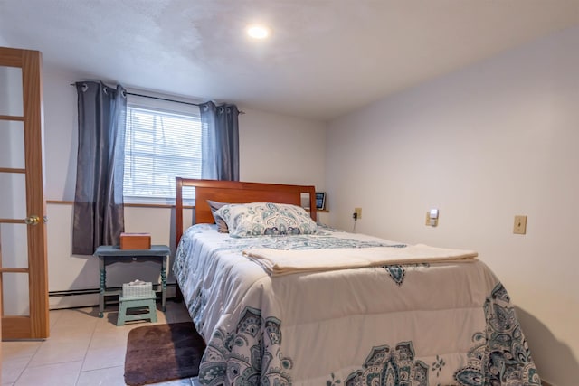 bedroom featuring baseboard heating and light tile patterned flooring