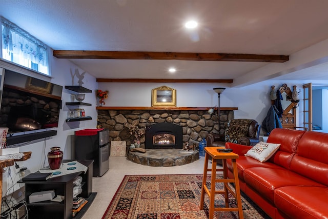 living room with beamed ceiling and a stone fireplace