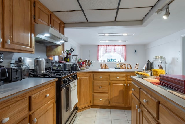 kitchen with light tile patterned floors and stainless steel range with gas stovetop