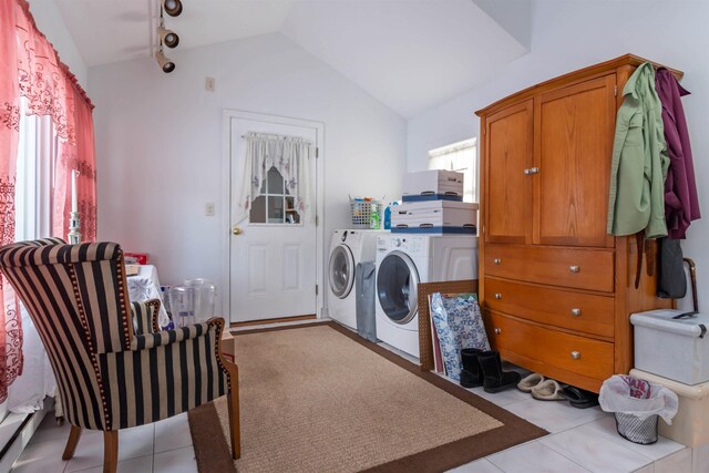 washroom with light tile patterned floors, washer and clothes dryer, and rail lighting