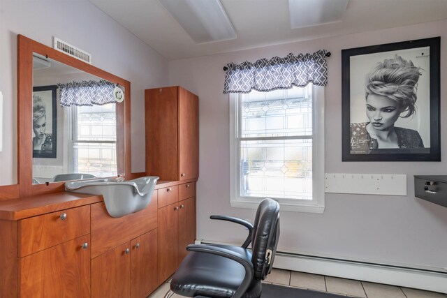 tiled home office with a baseboard heating unit