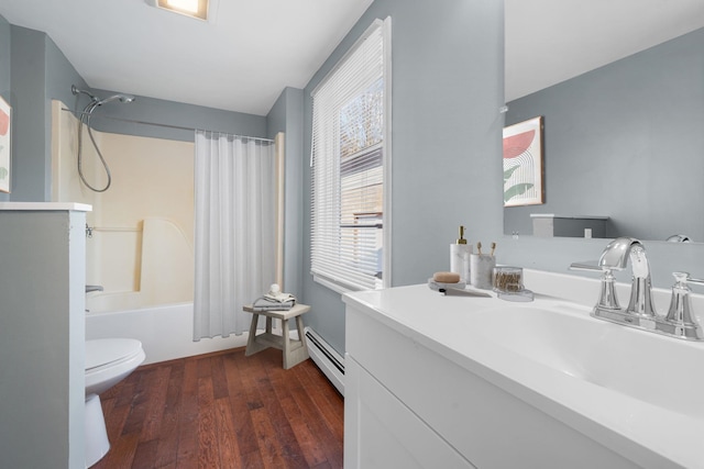 full bathroom with hardwood / wood-style floors, shower / bath combination with curtain, toilet, vanity, and a baseboard heating unit