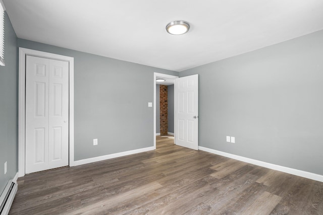 interior space with a baseboard radiator and dark hardwood / wood-style floors