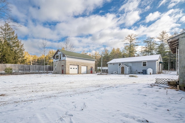 exterior space with a garage and an outbuilding