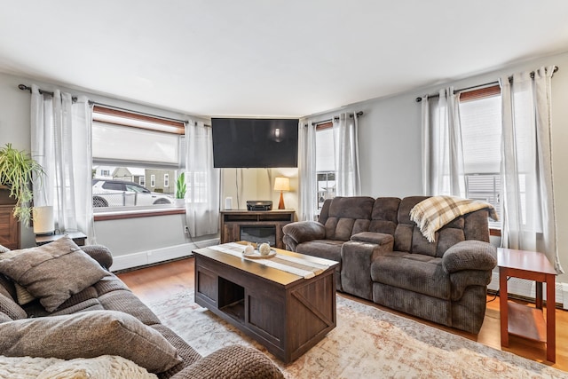 living room with a wealth of natural light and light hardwood / wood-style floors