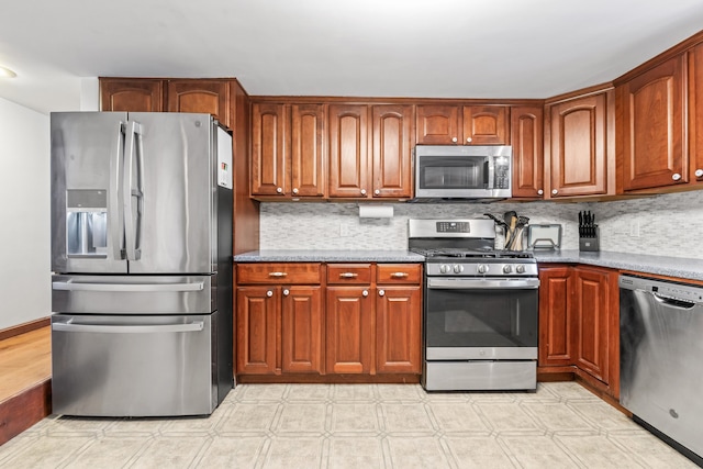 kitchen with stainless steel appliances and backsplash