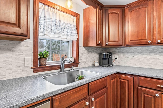 kitchen with sink, dishwasher, and tasteful backsplash