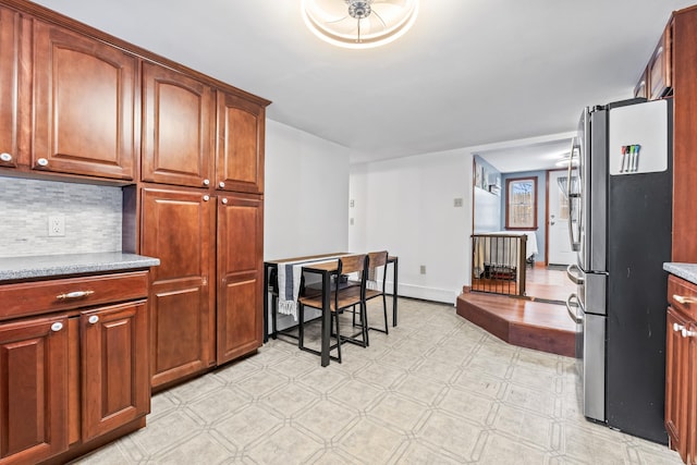 kitchen with stainless steel fridge and backsplash