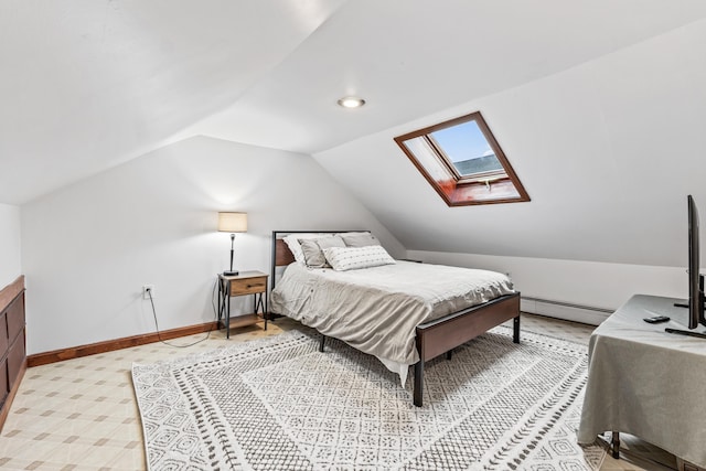 bedroom featuring lofted ceiling with skylight and a baseboard heating unit