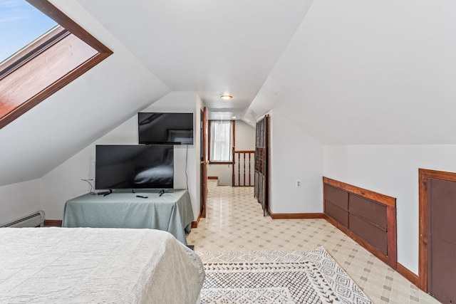 bedroom with baseboard heating and vaulted ceiling