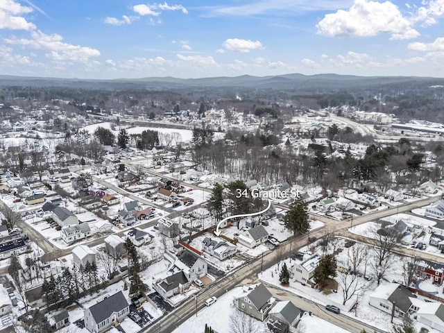 snowy aerial view with a mountain view