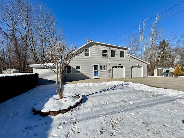 snow covered house with a garage