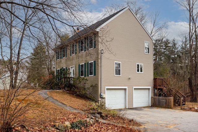 view of side of home featuring a garage