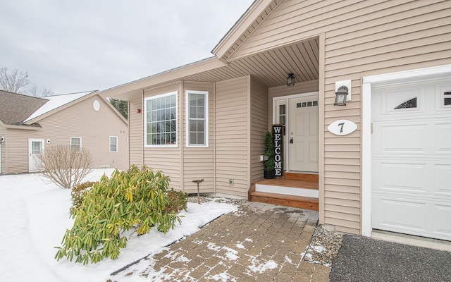 view of snow covered property entrance