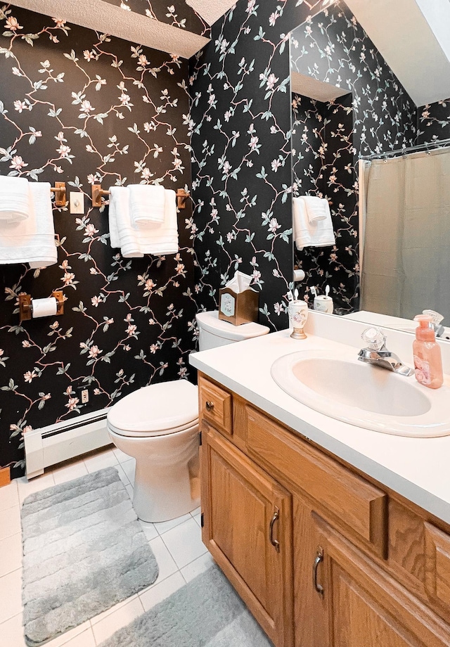 bathroom with toilet, a baseboard heating unit, tile patterned floors, and vanity