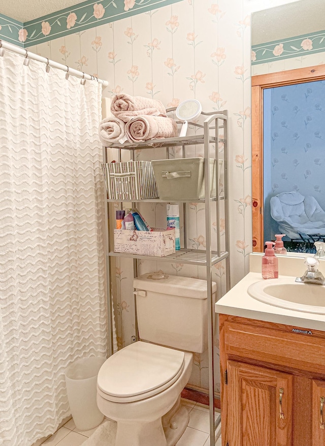 bathroom with a shower with curtain, tile patterned flooring, vanity, and toilet