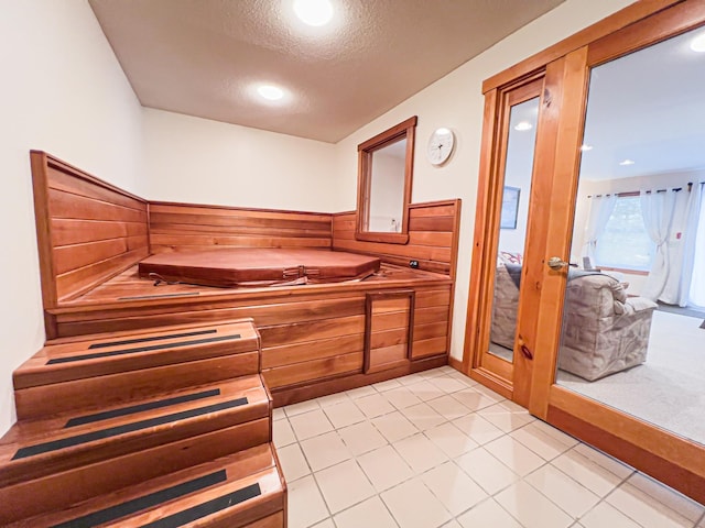 bathroom featuring a textured ceiling and tile patterned floors