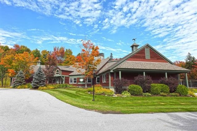 view of side of property with a yard