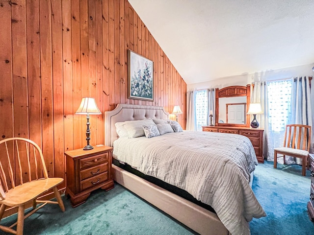 bedroom featuring multiple windows, wooden walls, lofted ceiling, and carpet flooring