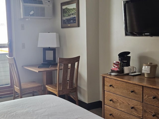 bedroom featuring a wall mounted air conditioner