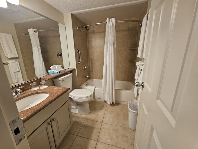 full bathroom featuring toilet, vanity, tile patterned floors, shower / bath combo, and a textured ceiling