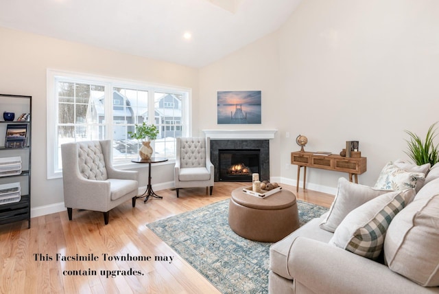 living room featuring lofted ceiling and hardwood / wood-style flooring