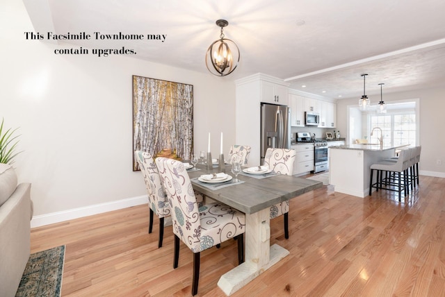 dining room featuring light hardwood / wood-style floors and an inviting chandelier