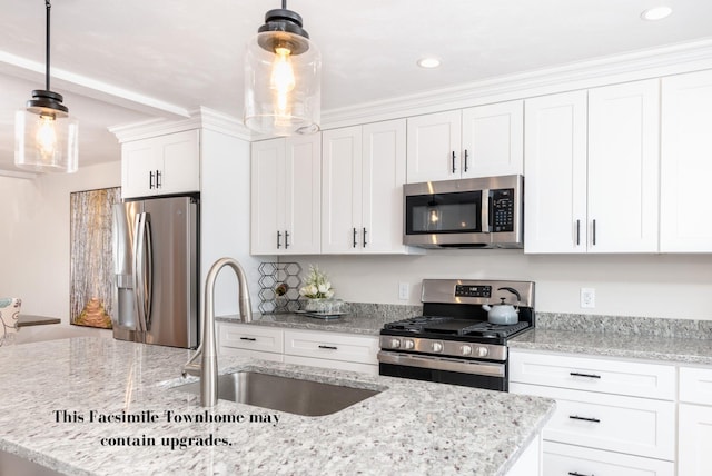 kitchen featuring stainless steel appliances, sink, white cabinets, hanging light fixtures, and light stone countertops