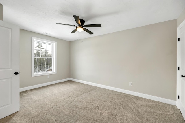 carpeted spare room with ceiling fan