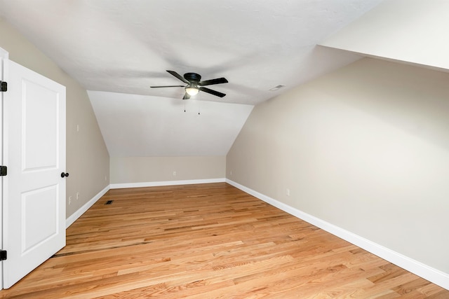 additional living space featuring ceiling fan, vaulted ceiling, and light wood-type flooring