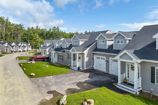 view of front of property featuring a front lawn and a garage