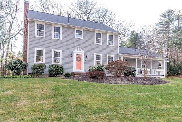 colonial-style house with covered porch and a front lawn