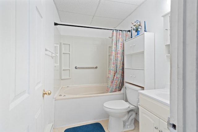 full bathroom with a drop ceiling, shower / tub combo, toilet, tile patterned floors, and vanity