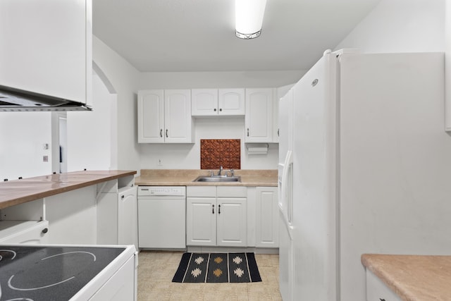 kitchen with sink, white appliances, and white cabinetry