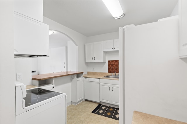 kitchen featuring sink, white appliances, white cabinetry, and butcher block countertops