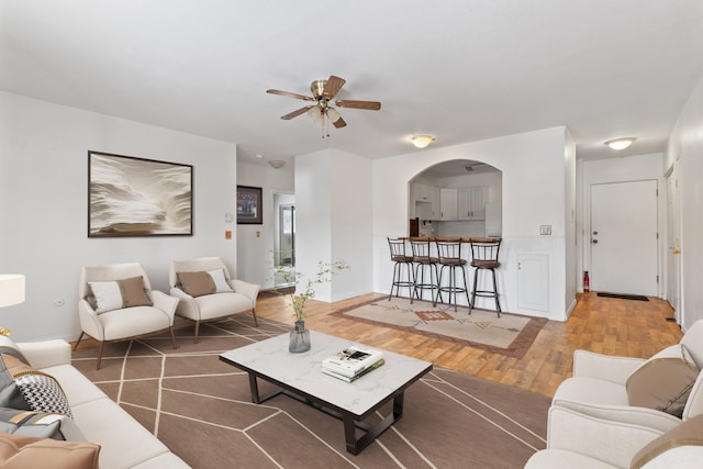 living room with ceiling fan and hardwood / wood-style floors