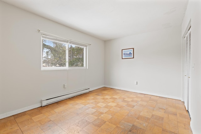 unfurnished room featuring baseboard heating