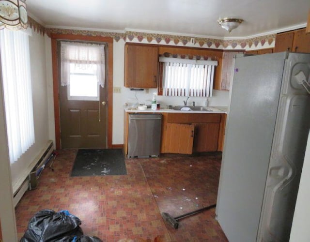 kitchen with stainless steel dishwasher, sink, and white fridge