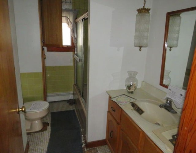 bathroom featuring toilet, walk in shower, and vanity