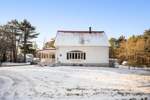 snow covered property featuring a porch