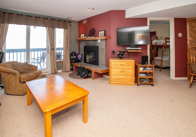 carpeted living room featuring a tile fireplace