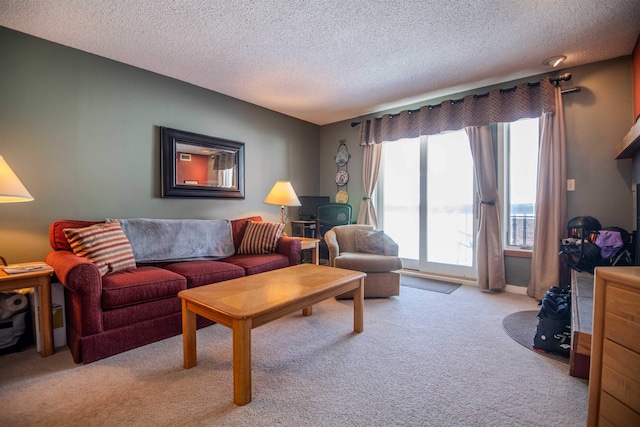 carpeted living room featuring a textured ceiling