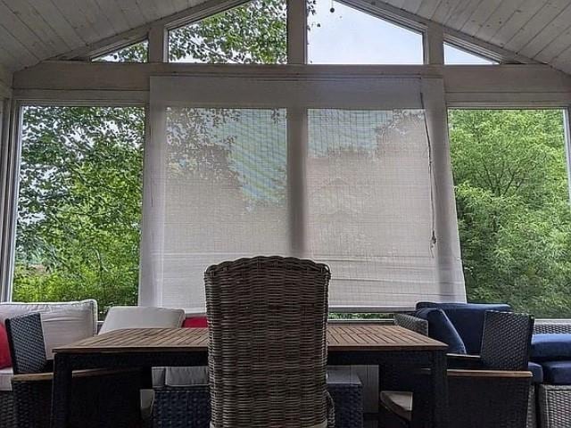 sunroom / solarium featuring lofted ceiling