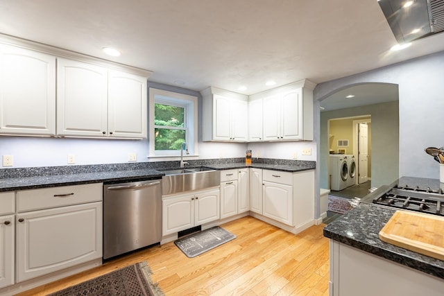 kitchen with sink, white cabinets, light wood-type flooring, stainless steel dishwasher, and washer and dryer