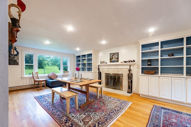 living room featuring light hardwood / wood-style flooring and a baseboard heating unit