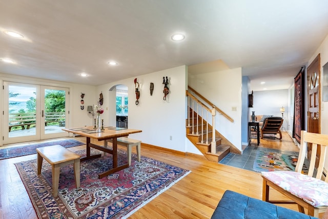 dining area with french doors and hardwood / wood-style flooring