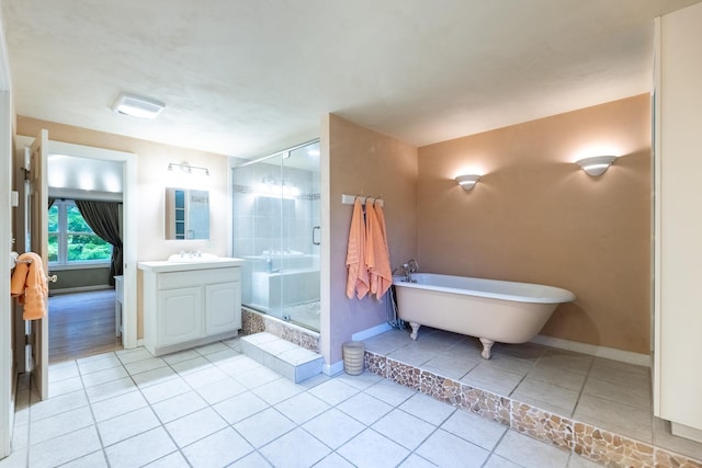 bathroom with tile patterned flooring, plus walk in shower, and vanity