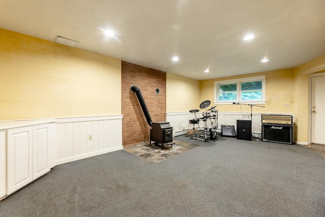 workout area with carpet and a wood stove