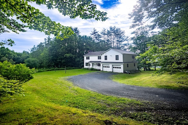 view of front of house featuring a front lawn and a garage