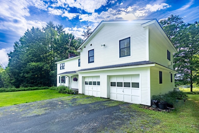 view of property exterior with a garage and a yard